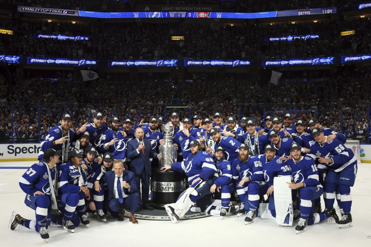 The Tampa Bay Lightning pose with the Stanley Cup after defeating the Montreal Canadiens 1-0 in Game 5 on July 7, 2021.