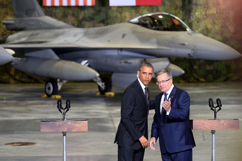 President Obama and Polish President Bronislaw Komorowski appear before U.S. and Polish airmen at Warsaw Chopin Airport. Poland is the first stop on a four-day European trip by Obama.