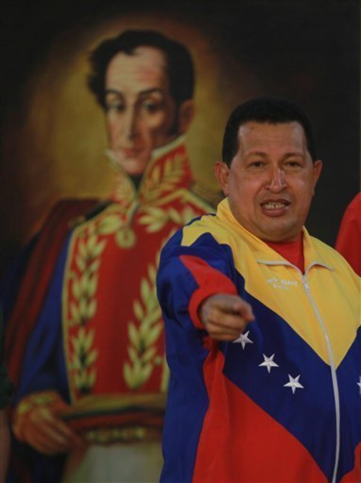 Venezuela's President Hugo Chavez gestures during a meeting with the athletes that will compete in the Central American Games at Miraflores presidential palace in Caracas, Wednesday, July 14, 2010. The games will be held July 16-Aug. 1 in Mayaguez, Puerto Rico. The painting at back portraits Venezuelan independence hero Simon Bolivar. (AP Photo/Fernando Llano)