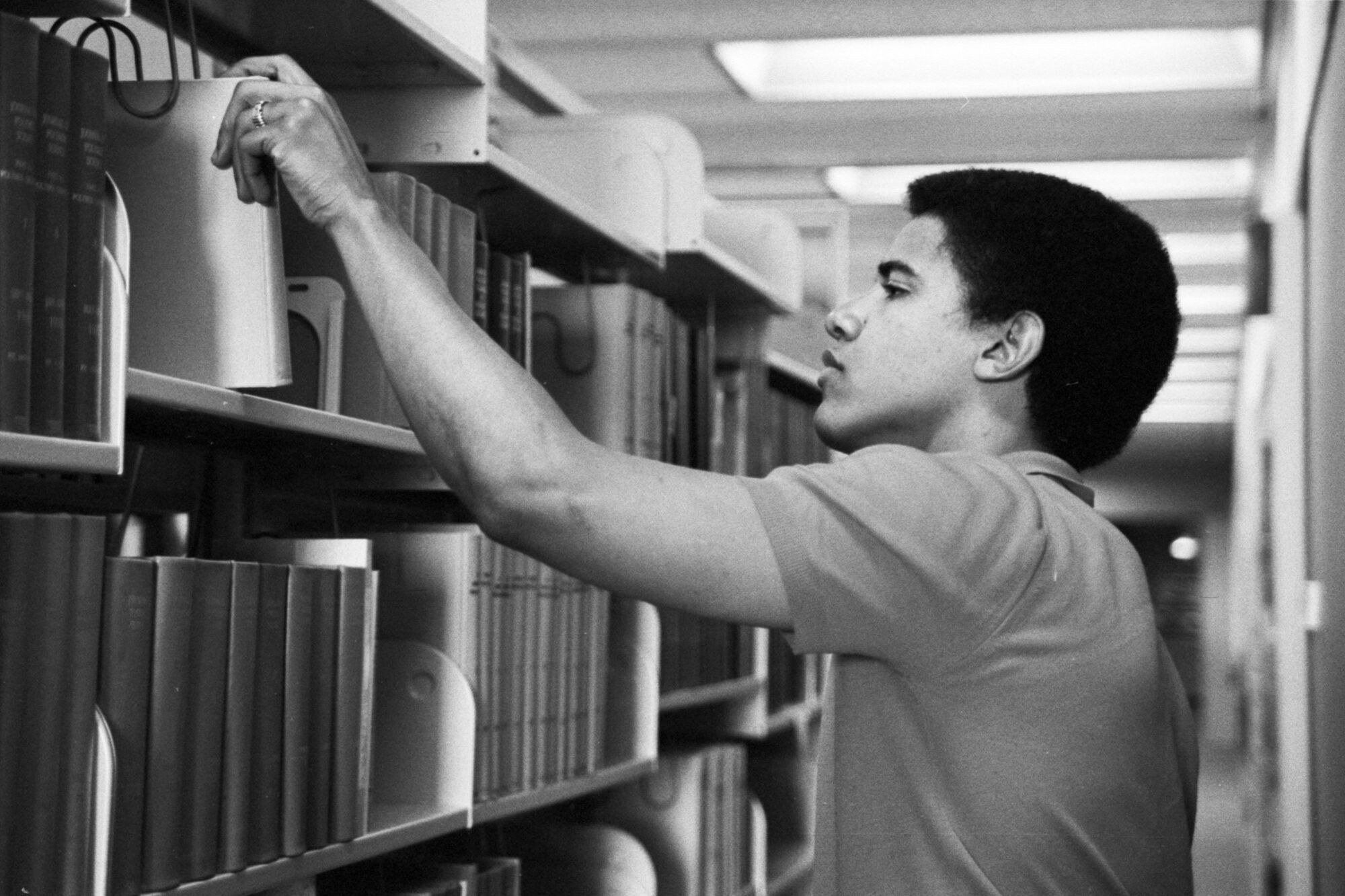 A young Barack Obama in the library at Occidental College.