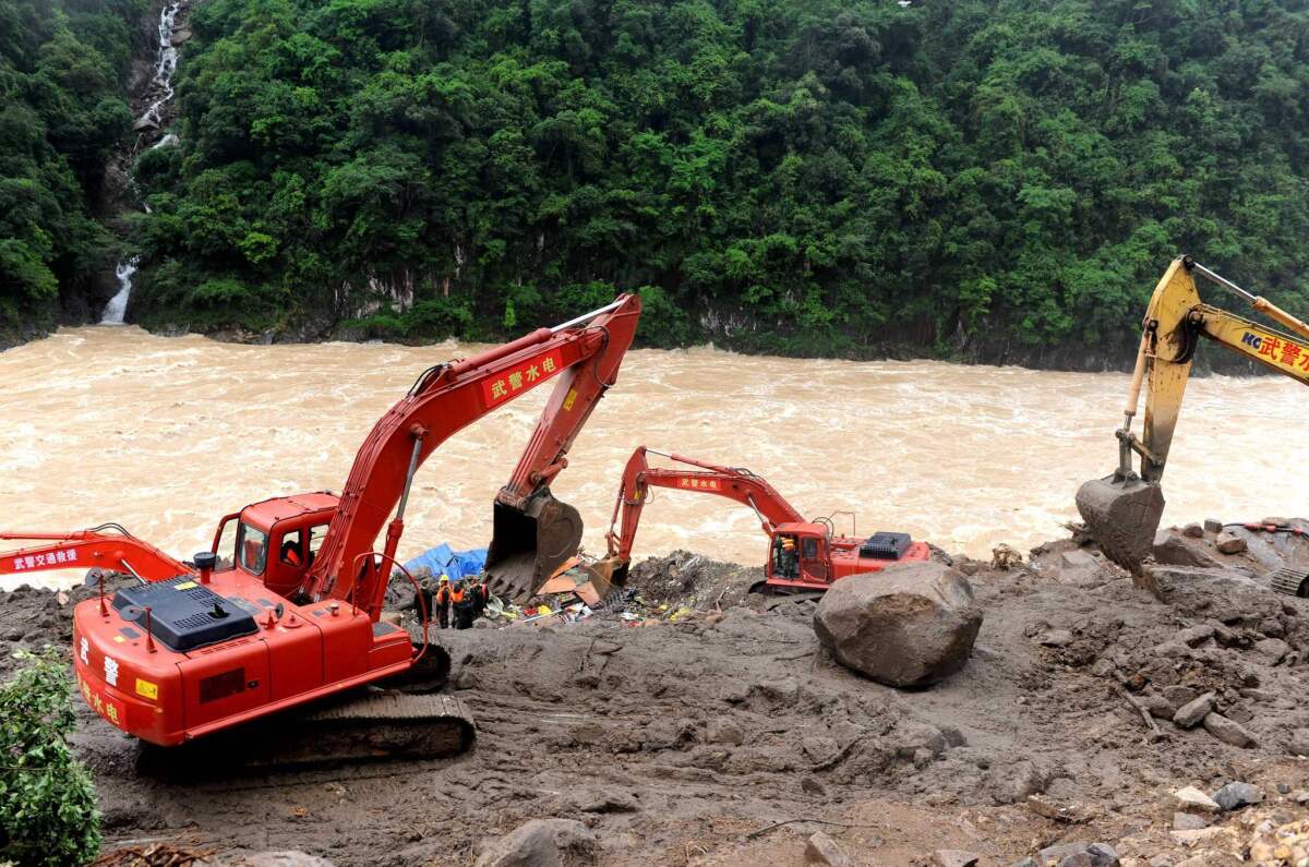 Rescuers search for survivors at the site of a landslide in China's Fujian province on May 9.