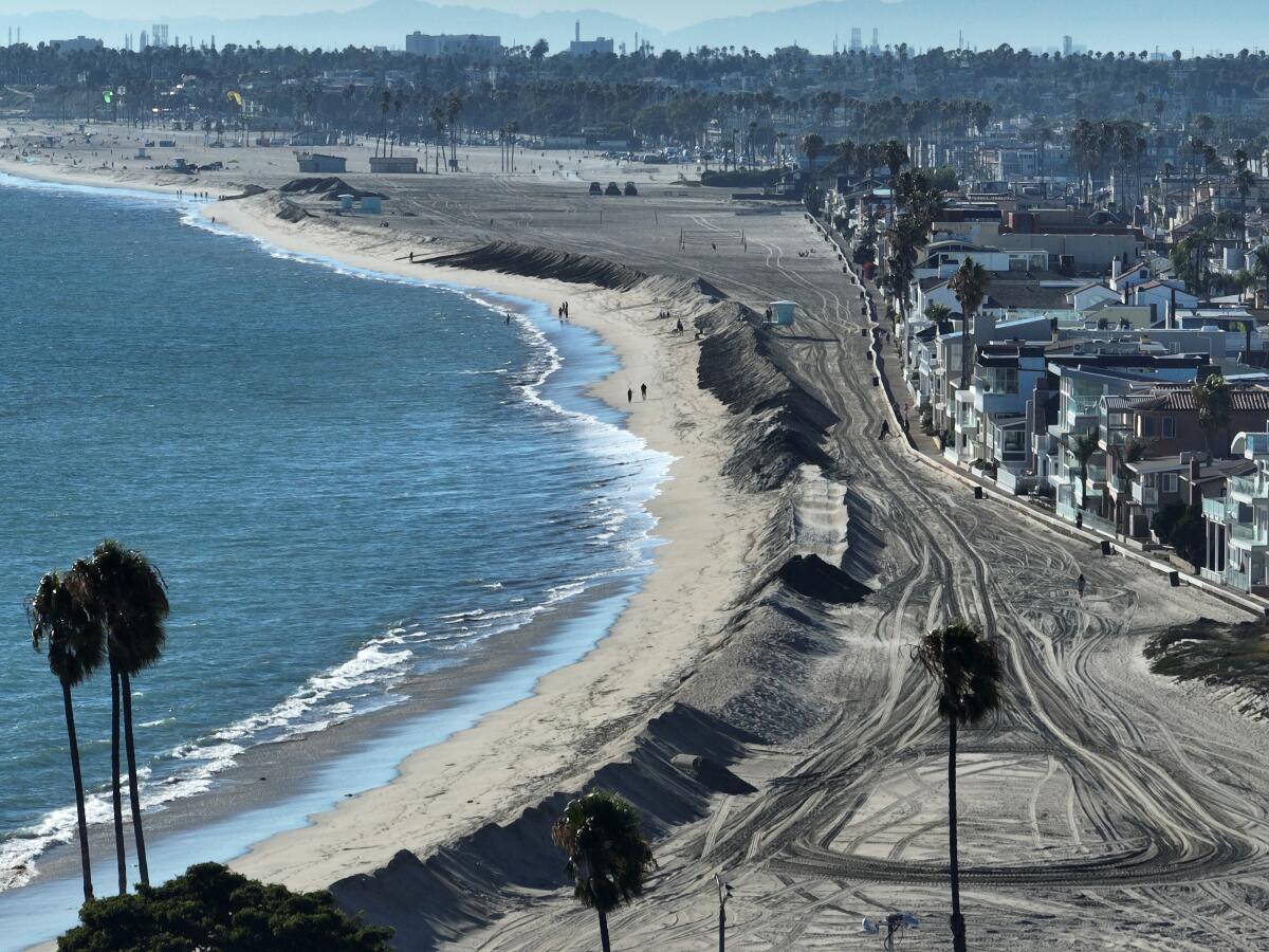 An aerial view of a sand berm on the shore of Long Beach near Alamitos Bay