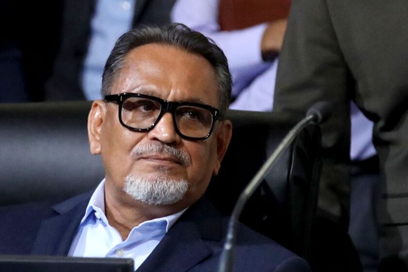 LOS ANGELES, CA - OCTOBER 11: Councilmember District 1 - Gil Cedillo at the Los Angeles City Council meeting at Los Angeles City Hall on Tuesday, Oct. 11, 2022 in Los Angeles, CA. Protestors want the resignation of Los Angeles Councilmembers Nury Martinez, Kevin de Leon and Gil Cedillo. Martinez made racist remarks about Councilmember Mike Bonin son in the recording as her colleagues, Councilmembers Kevin de Leon and Gill Cedillo, laughed and made wisecracks. (Gary Coronado / Los Angeles Times)