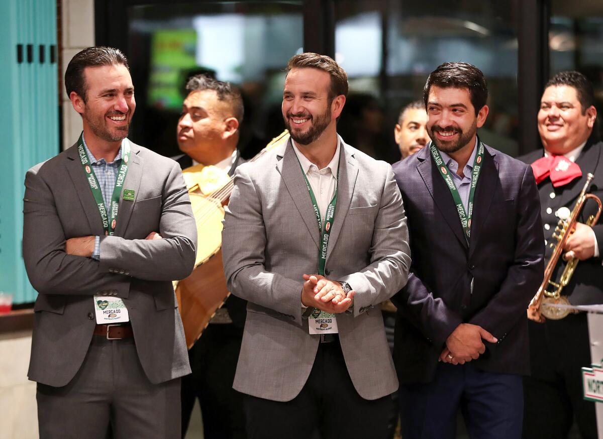 Manuel, Moises and Sergio González, from left, laugh with guests.
