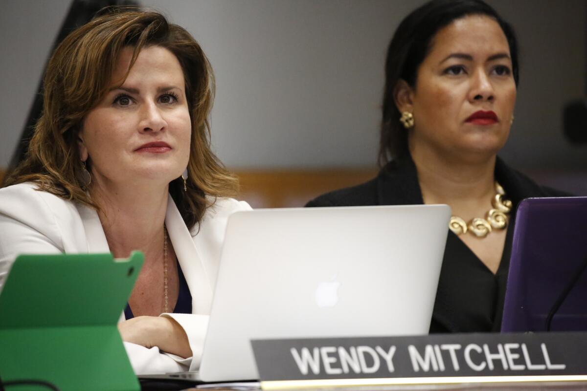 California Coastal Commissioners Wendy Mitchell, left, and Effie Turnbull-Sanders listen to speakers at a meeting in Morro Bay, where the panel voted Feb. 10 to fire Executive Director Charles Lester.