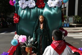 Adriana Diaz of Immaculate Heart of Mary Catholic Church in Ramona portrays Guadalupe during the Procession to Honor Our Lady of Guadalupe in downtown San Diego on Dec. 1, 2019.