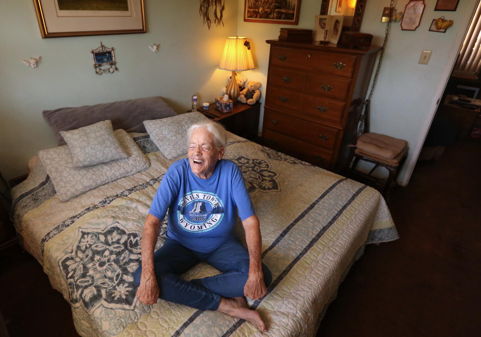Donna Martin, 77, rests on her waterbed in her apartment in Glendale.