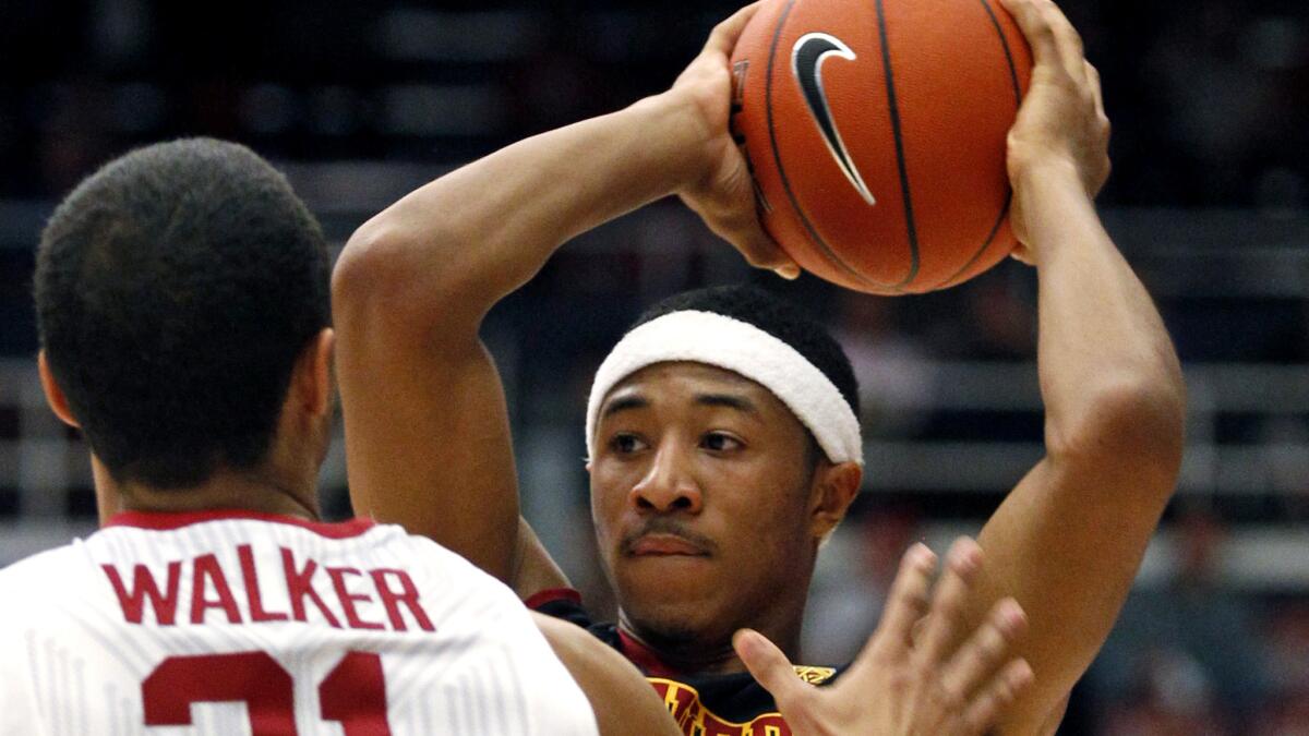 USC guard Elijah Stewart looks to pass against Stanford's Cameron Walker during the first half Thursday night.