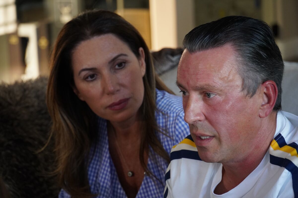 Galina Blank, left, and husband Edward Chatokhin are photographed at their home in Sherman Oaks, Calif, March 3, 2022. Chatokhin’s sister and mother are in Ukraine and seeking to come to the US. They've called their Congressional representative and the State Department, desperate to get the family out. (AP Photo/Eugene Garcia)