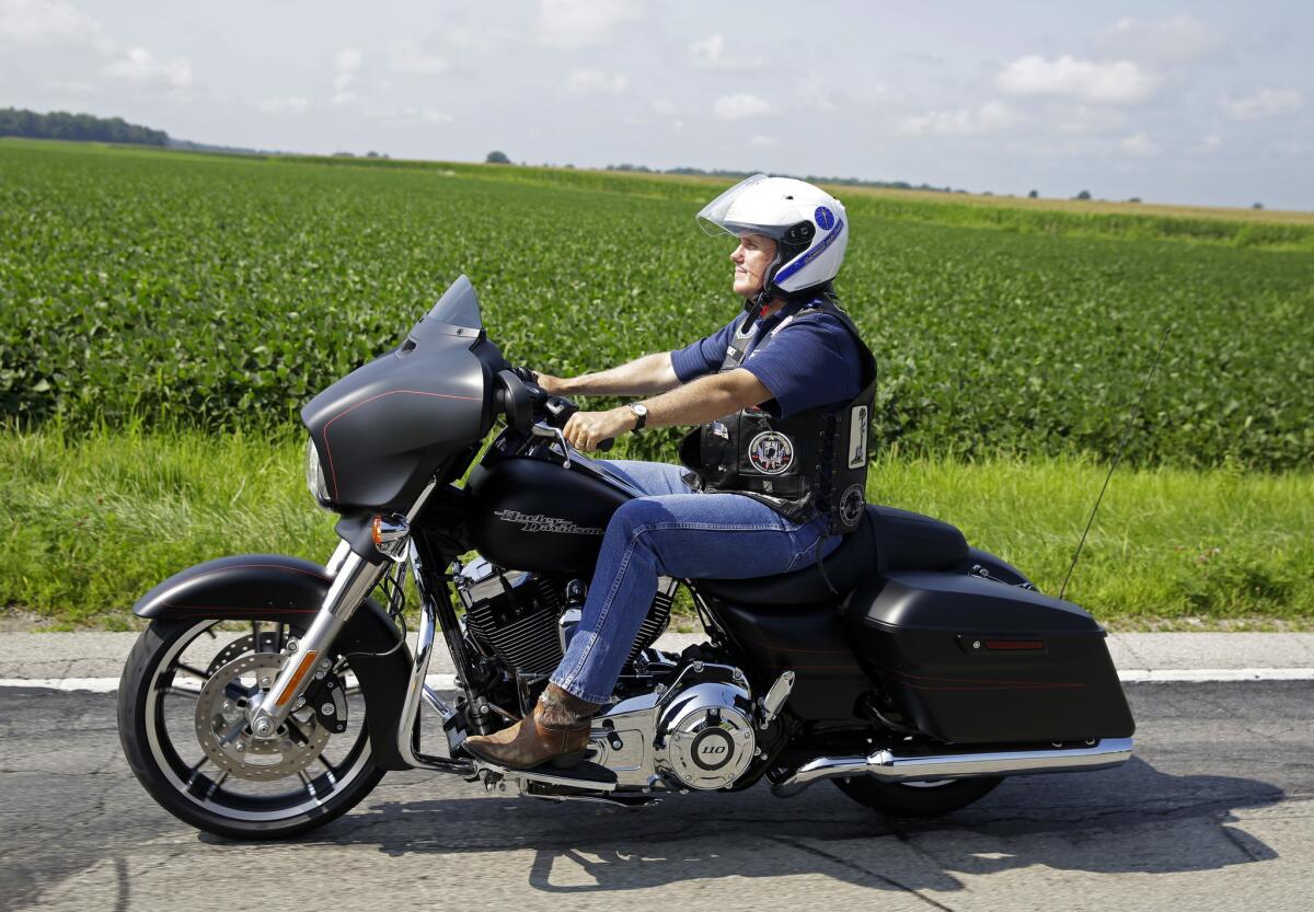 Republican vice presidential candidate and Indiana Gov. Mike Pence participates in a motorcycle ride to benefit the Indiana National Guard in Fountaintown, Ind., on July 29, 2016.