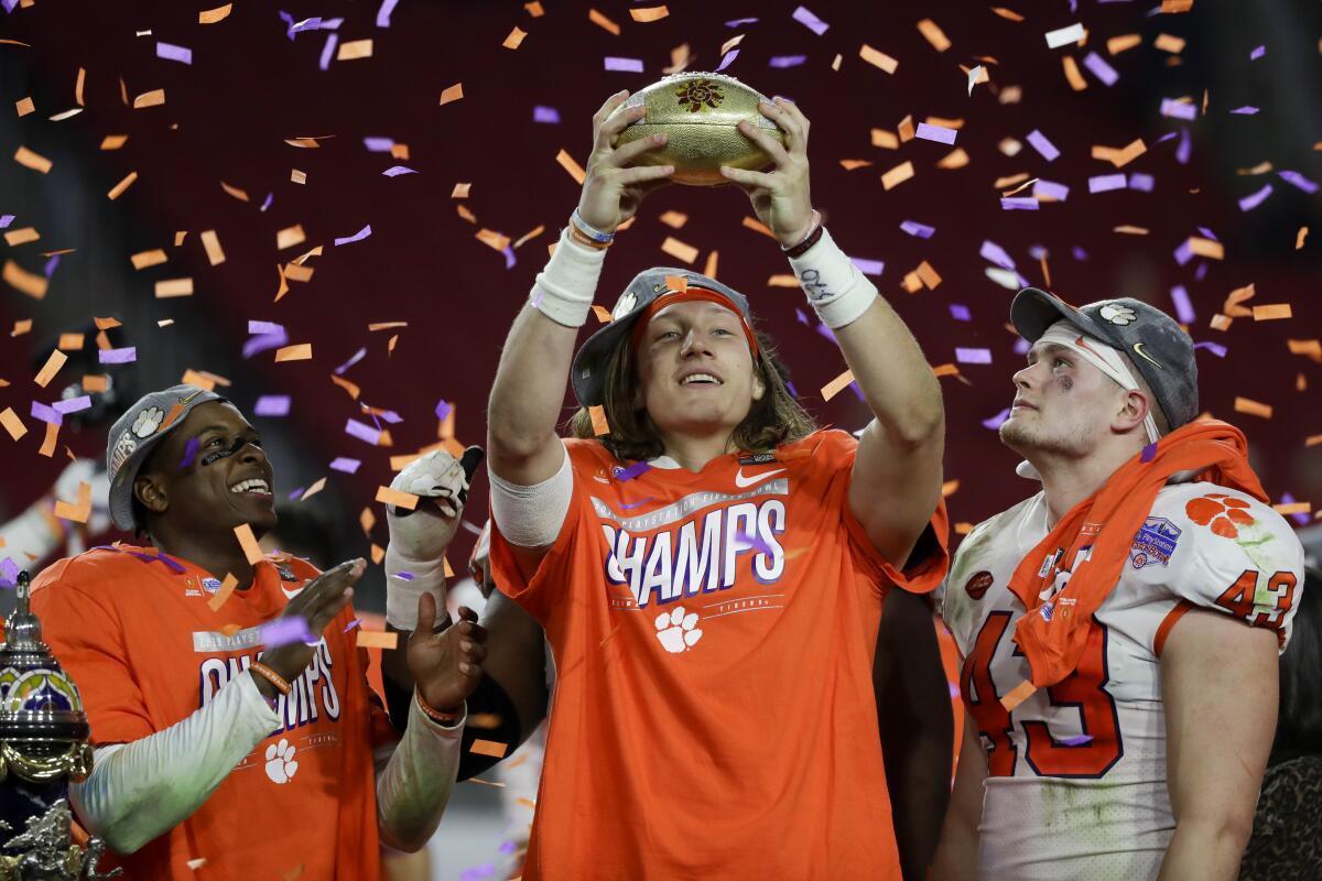 Clemson quarterback Trevor Lawrence, middle, and teammates celebrate their Fiesta Bowl victory Dec. 29, 2019.
