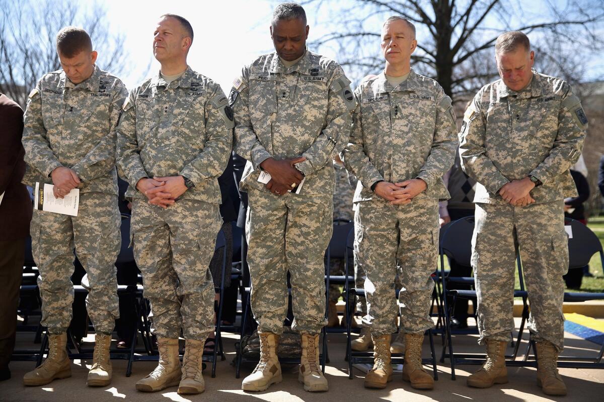 ARLINGTON, VA - MARCH 31: U.S. Army generals bow their heads in prayer during the commencement ceremony for the Army's annual observance of Sexual Assault Awareness and Prevention Month in the Pentagon Center Courtyard March 31, 2015 in Arlington, Virginia. In conjunction with the national campaign against sexual assault, The Army announced this year's theme, 'Not in My Squad. Not in Our Army. We are Trusted Professionals,' during the ceremony. According to the Pentagon, the initative 'is a grassroots approach meant to reinforce a climate of dignity and respect founded on good order and discipline.' (Photo by Chip Somodevilla/Getty Images) ** OUTS - ELSENT, FPG - OUTS * NM, PH, VA if sourced by CT, LA or MoD **