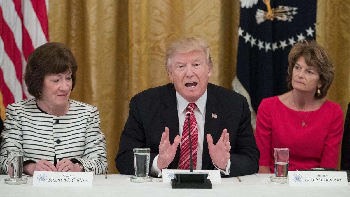 President Trump at a meeting at the White House on Tuesday flanked by Republican Sens. Susan Collins of Maine, left, and Lisa Murkowski of Alaska, both of whom have expressed reservations about the healthcare bill pending in the Senate.