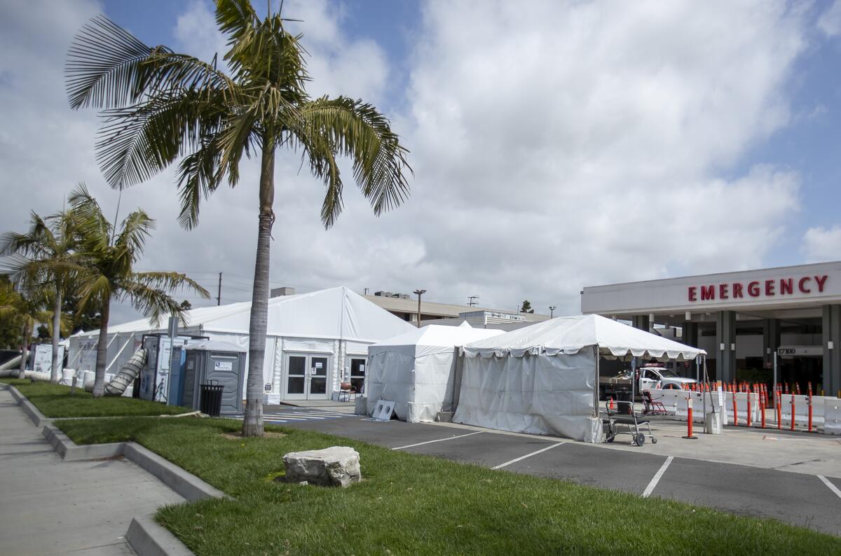 A tent outside the emergency room of the Fountain Valley Regional Hospital & Medical Center is used to screen people for coronavirus symptoms before allowing them inside the hospital on April 2.