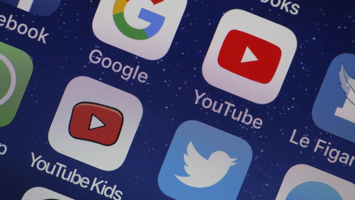 In this photo illustration, the logo of the Google, You Tube and You Tube Kids applications are displayed on the screen of an Apple iPhone on April 10, 2018 in Paris, France.