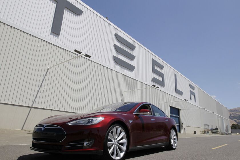 A Tesla Model S waits outside the Tesla factory in Fremont, Calif. Rumors are swirling that Tesla will begin making more cars in California at a facility the company has leased east of San Francisco in Lathrop.