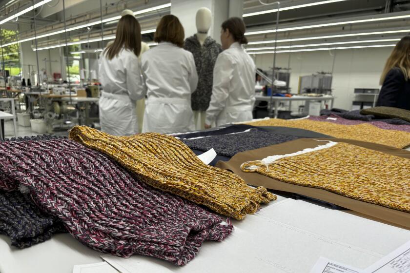 Knitwear created by Italian artisans for the Prada and Miu Miu brands sit on a desk at a recently expanded factory in the Perugia province of Italy, Tuesday, May 7, 2024. The Prada Group is expanding its production footprint in Italy, including dozens of new jobs at brand's knitwear factory near Umbria, leaning into Made in Italy as integral to the brand's ethos as it develops new artisanal talent to ease the luxury group through a generational shift in its workforce, alongside the management and creative transitions already under way. (AP Photo/Colleen Barry)