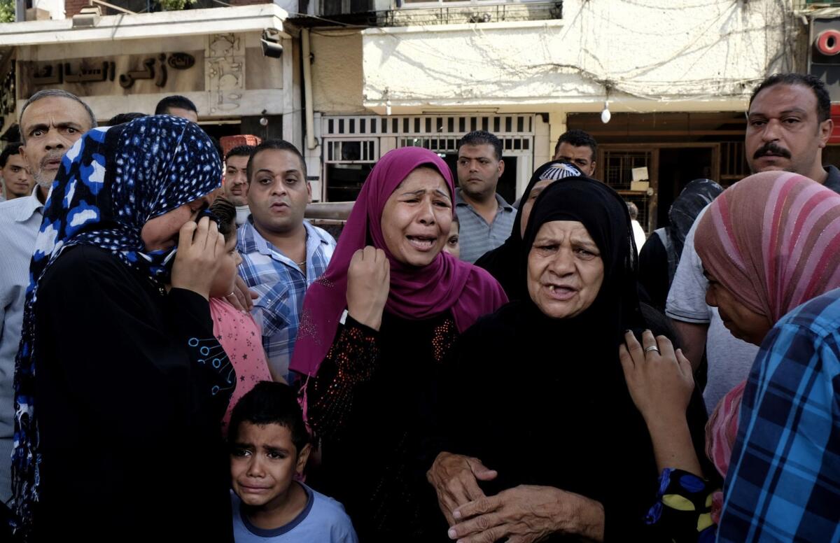 Egyptians gather at the scene of a roadside bomb blast near the Foreign Ministry in downtown Cairo.
