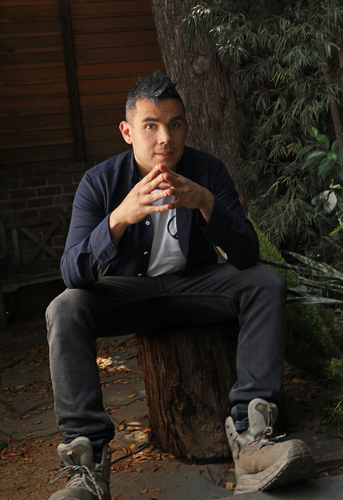 Rostam sitting in his backyard in L.A.