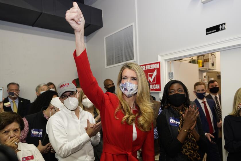 Republican candidate for U.S. Senate Sen. Kelly Loeffler gestures to supporters after speaking at a campaign rally Wednesday, Nov. 11, 2020, in Marietta, Ga. (AP Photo/John Bazemore)