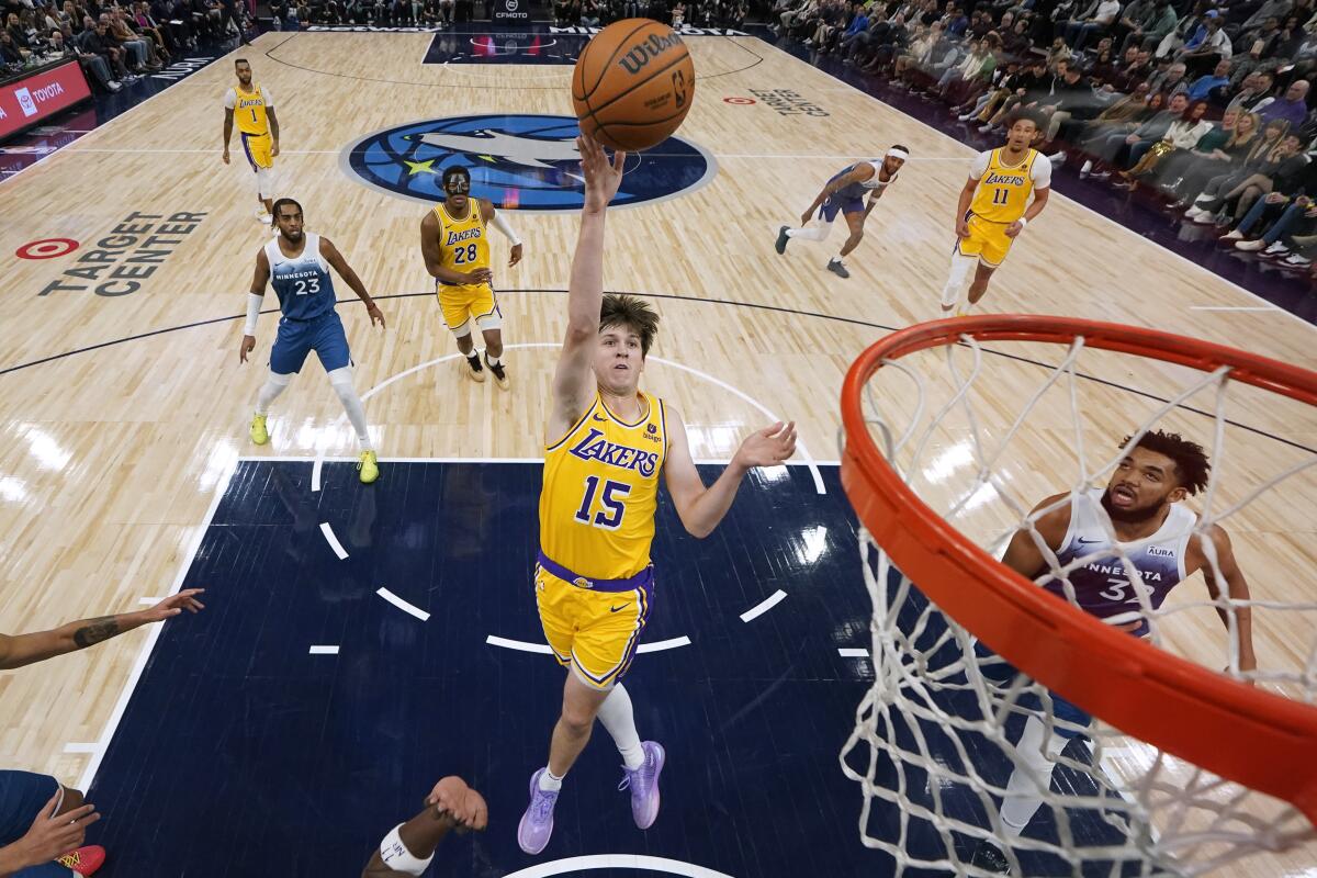 Lakers guard Austin Reaves shoots a floating jumper in the lane against the Timberwolves.