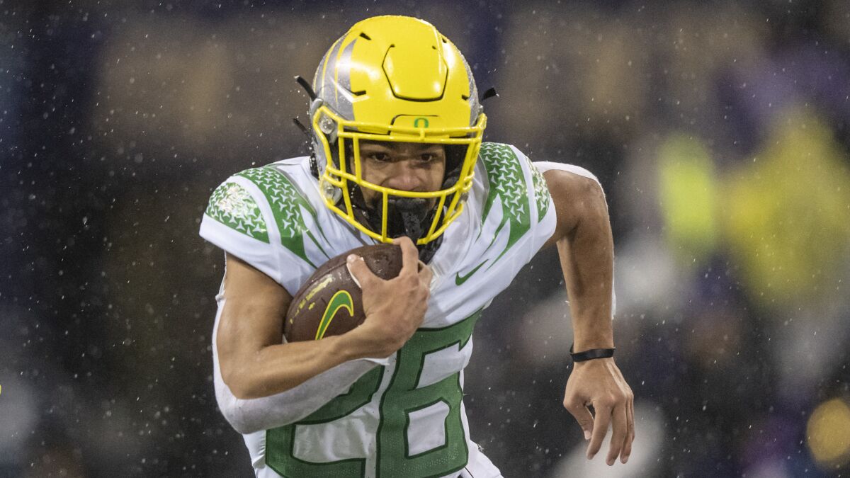 Oregon running back Travis Dye carries the ball during the 2021 season