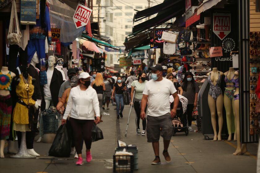 LOS ANGELES, CA - SEPTEMBER 10: People walk along Santee Alley in downtown on Thursday, Sept. 10, 2020 in Los Angeles, CA. (Dania Maxwell / Los Angeles Times)