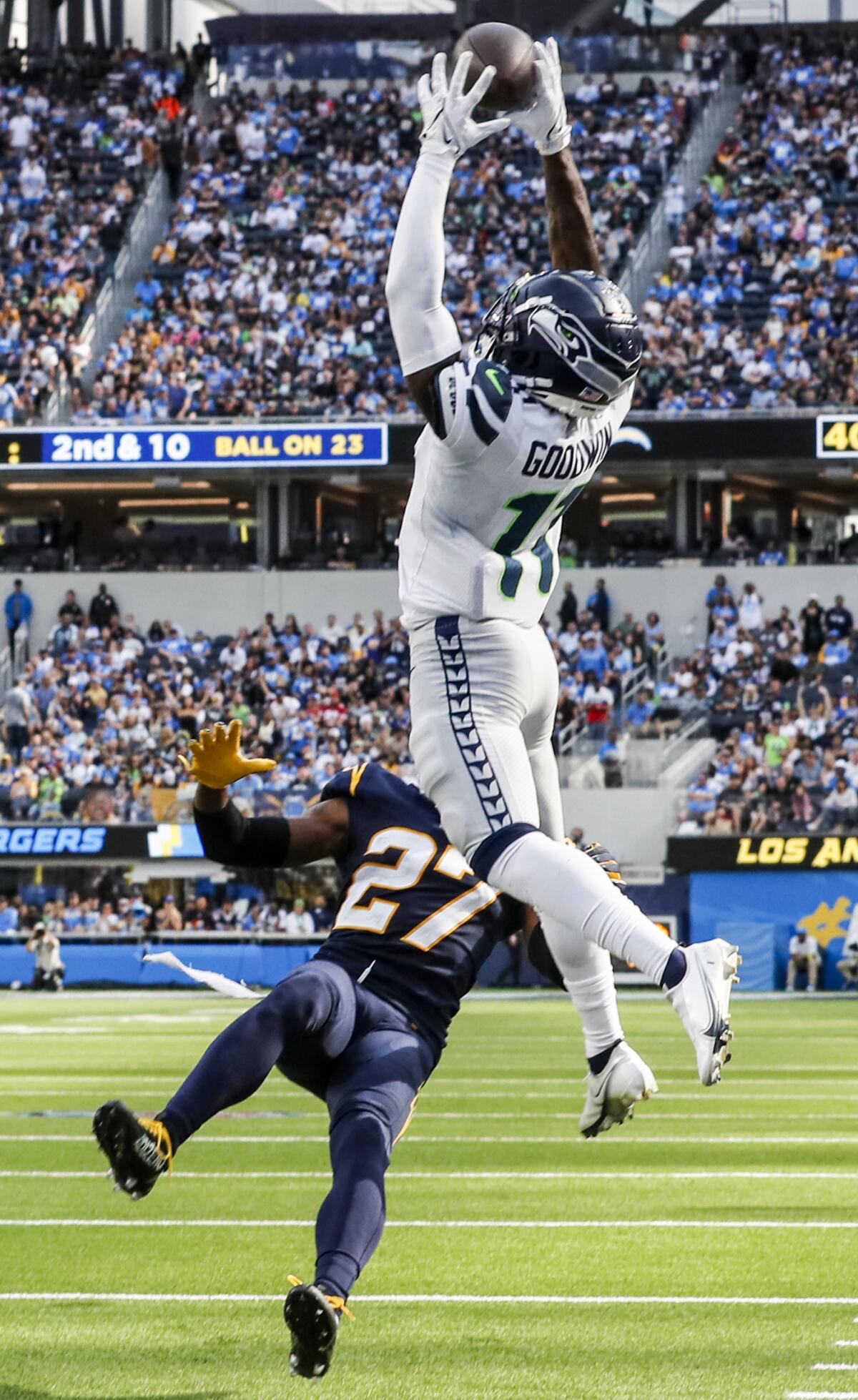 Seattle's Marquise Goodwin (11) catches a TD pass after Chargers corner J.C. Jackson (27) fell because of an injured knee.
