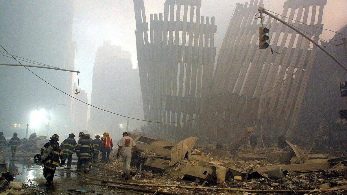 Firefighters make their way through the rubble of the World Trade Center. The work probably made them more likely to develop certain types of cancer, according to new research.