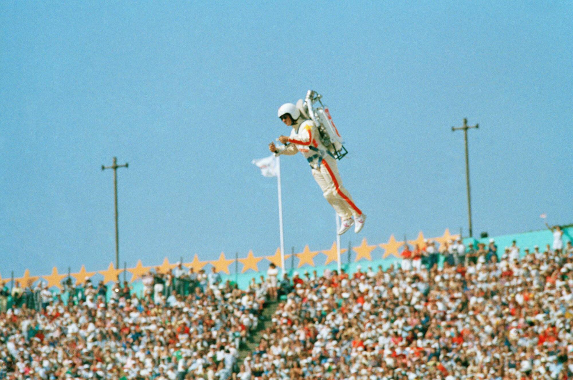 "Rocket Man" soars with the help of a jet pack during the welcoming of nations at the 1984 Olympics at the Coliseum.