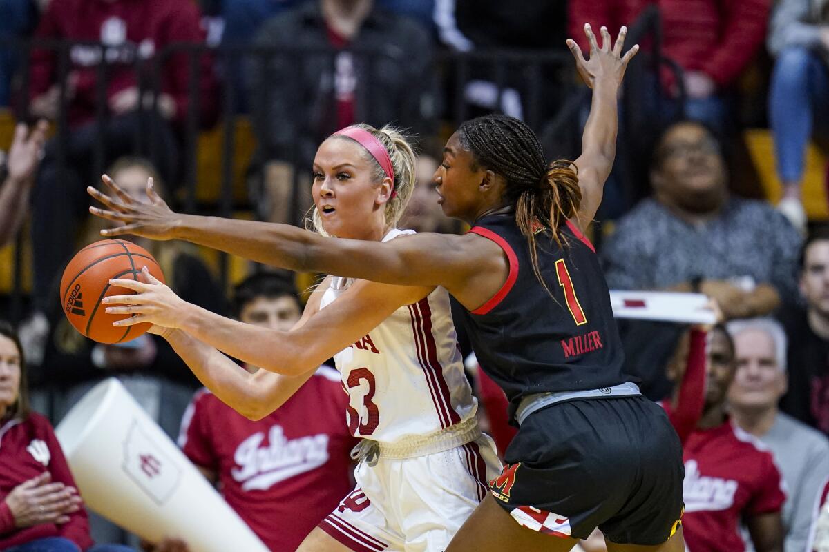 Maryland guard Diamond Miller (1) defends Indiana guard Sydney Parrish (33) in the first half of an NCAA college basketball game in Bloomington, Ind., Thursday, Jan. 12, 2023. (AP Photo/Michael Conroy)