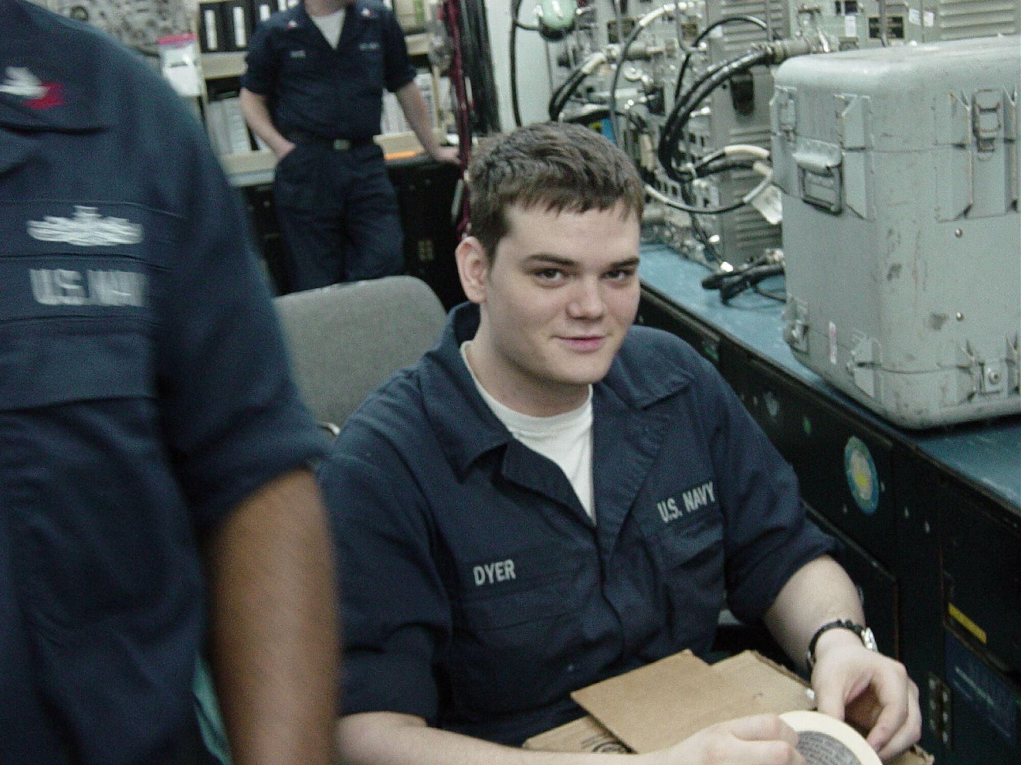 Airman Apprentice Andrew Dyer in an aviation electronics shop on board the aircraft carrier Kitty Hawk