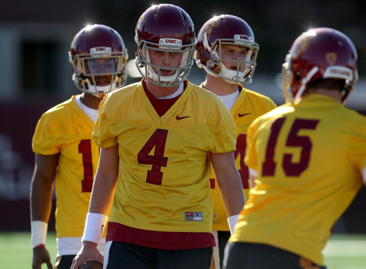 USC quarterbacks Jalen Greene, left, Max Browne (4) and Sam Darnold, second from right, work out on the first day of spring practice.