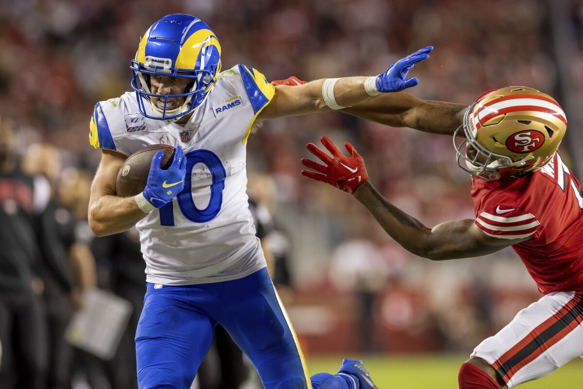 Rams wide receiver Cooper Kupp catches a pass and runs against the San Francisco 49ers.