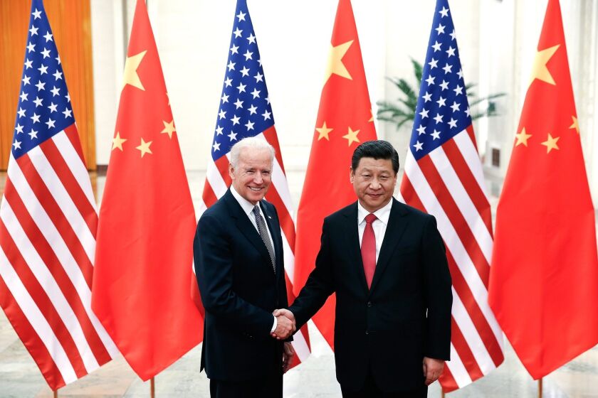 Chinese President Xi Jinping, right, shakes hands with Vice President Joseph Biden in the Great Hall of the People in Beijing on Wednesday.