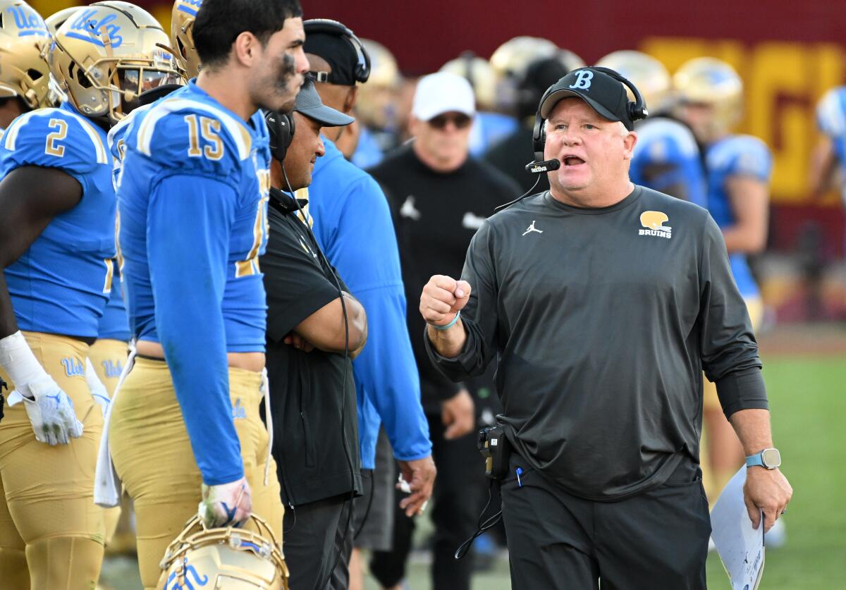 UCLA coach Chip Kelly walks on the sideline during a win over USC at the Coliseum on Nov. 18.
