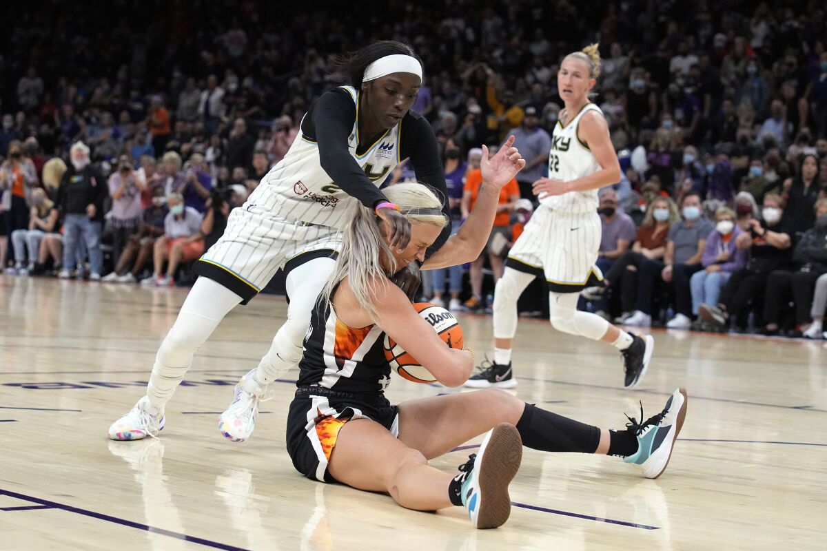Chicago Sky forward Kahleah Copper (2) and Phoenix Mercury guard Sophie Cunningham (9) compete for a loose ball during the first half of Game 2 of basketball's WNBA Finals, Wednesday, Oct. 13, 2021, in Phoenix. (AP Photo/Rick Scuteri)