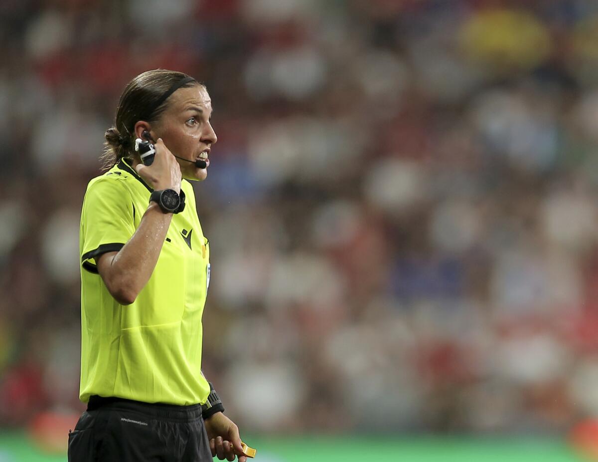 Referee Stephanie Frappart of France discusses with Chelsea players during the UEFA Super Cup soccer match between Liverpool and Chelsea, in Besiktas Park, in Istanbul, Wednesday, Aug. 14, 2019. (AP Photo)