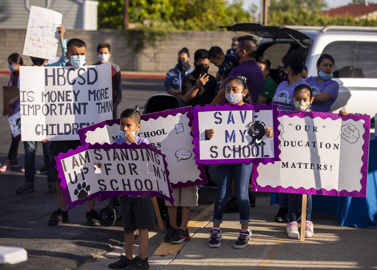 Students and family members walk along Beach Blvd. in protest of the closure of Perry Elementary School in Huntington Beach.