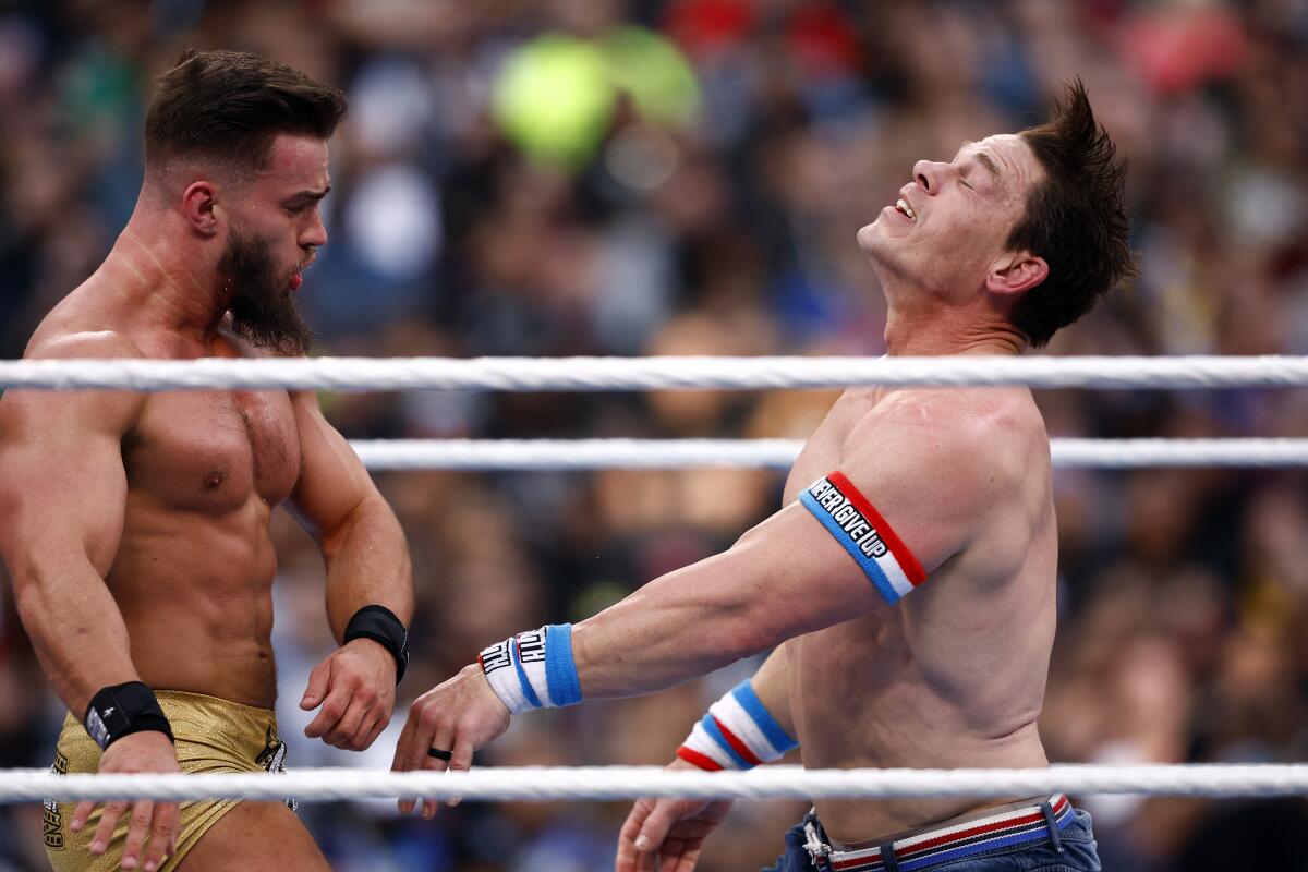 Austin Theory, left, fights John Cena for the WWE U.S. championship at SoFi Stadium.