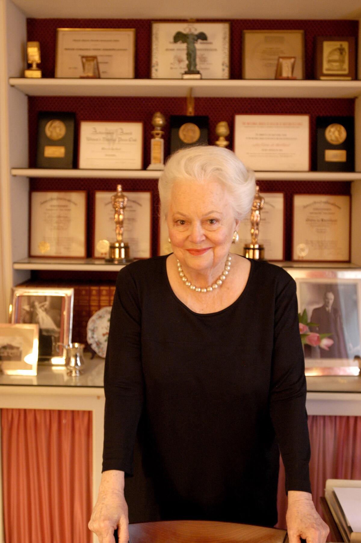 Actress Olivia de Havilland poses with her accolades at home in Paris in 2003. (Jean-Marc Giboux / Getty Images / For The Times)