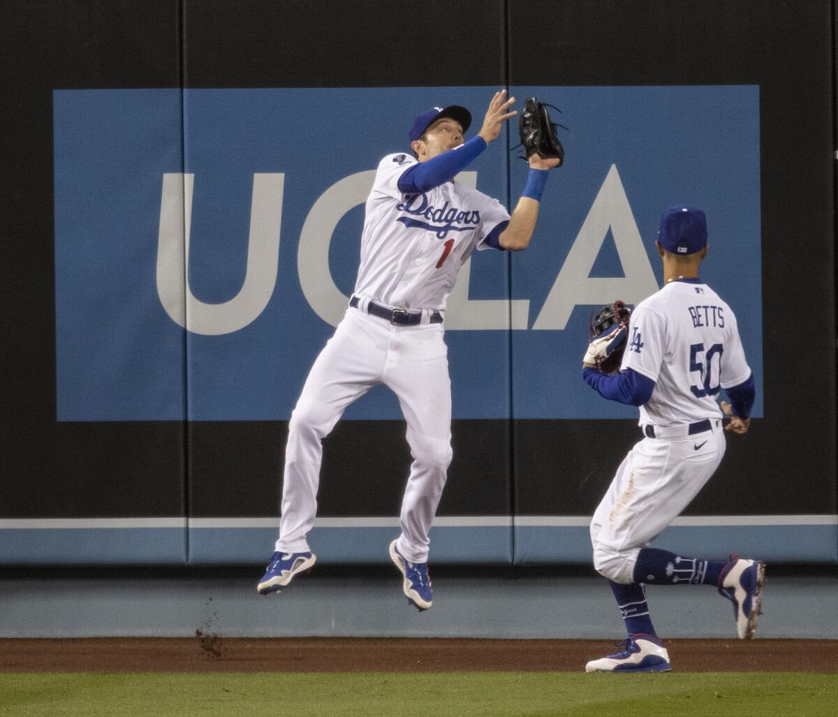 The Dodgers' AJ Pollock leaps up to make a catch 