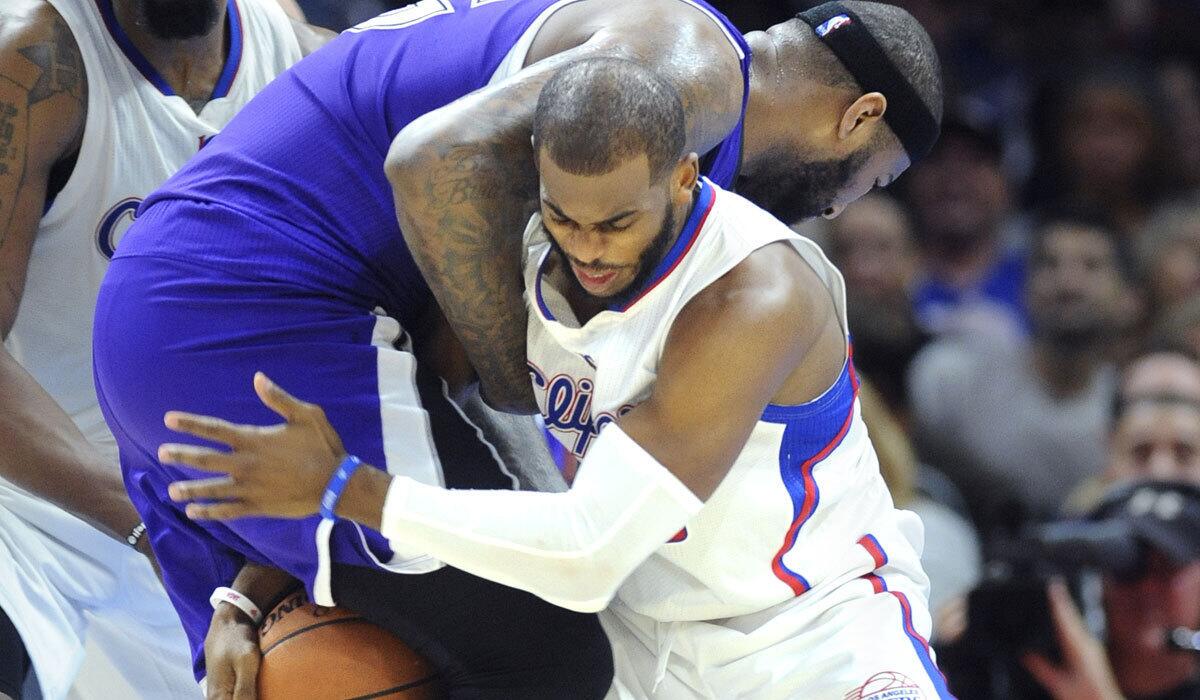 Chris Paul tries to steal the ball from Sacramento's DeMarcus Cousins in February.