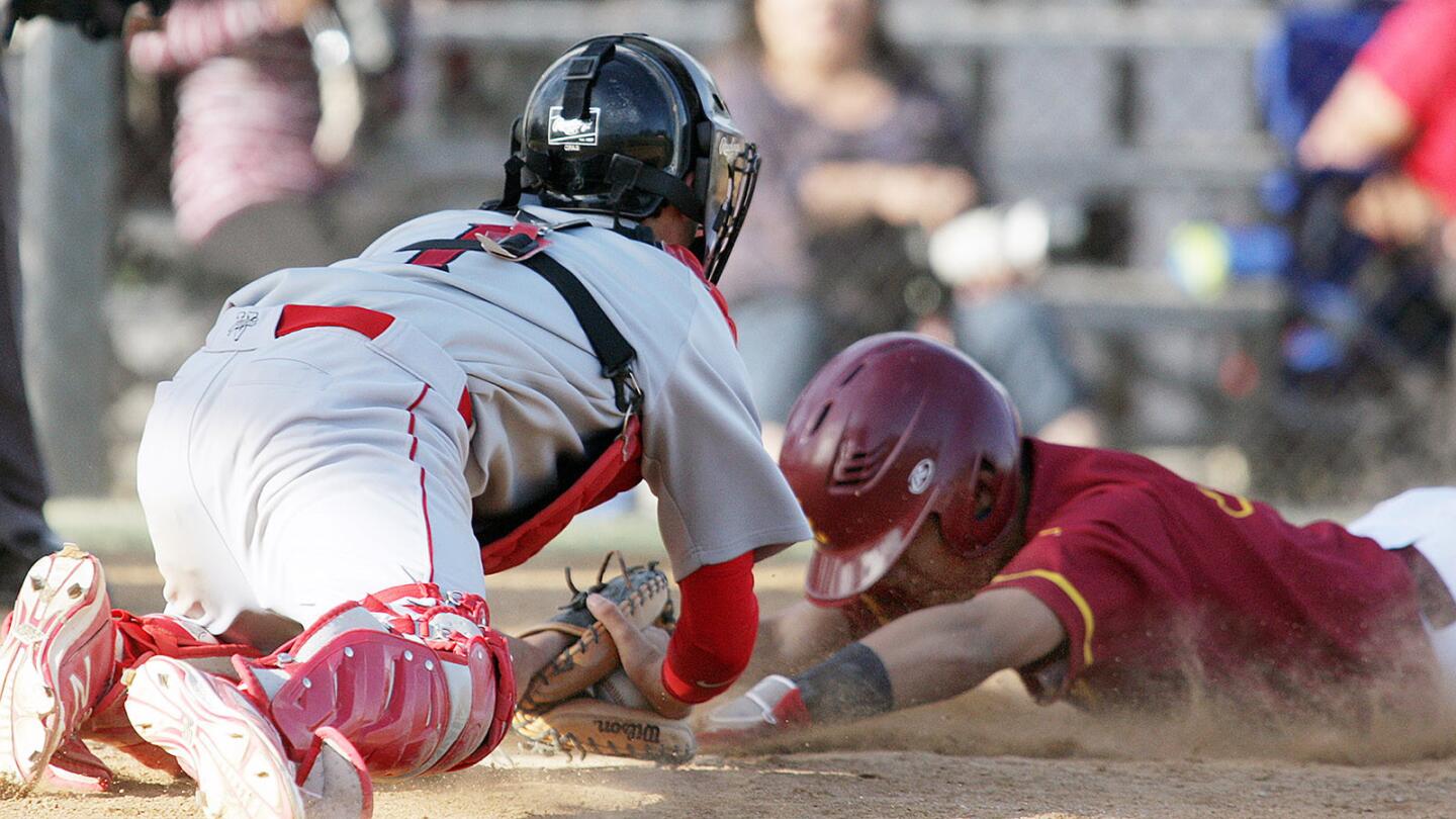 Burroughs' catcher Tanner Whitlock, with the ball in the glove, dives toward homeplate as Arcadia's Steven Wong slides in head first in a Pacific League baseball game at Arcadia High School on Friday, April 22, 2016. Burroughs won the game 3-2. The game ending play was controversial when the umpire called Wong out, a play that would have tied the game for Arcadia.