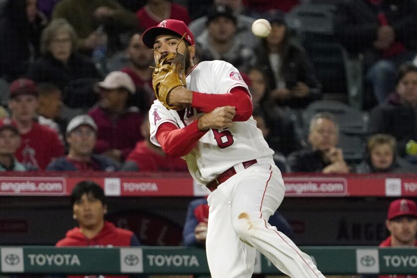 Los Angeles Angels third baseman Anthony Rendon attempts to throw out Baltimore Orioles' Austin Hays.