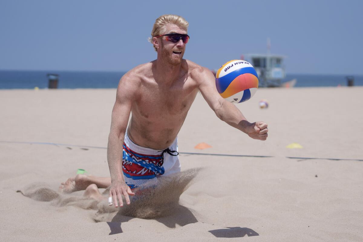 Chase Budinger dives for the ball during beach volleyball training on the sands of Hermosa Beach.