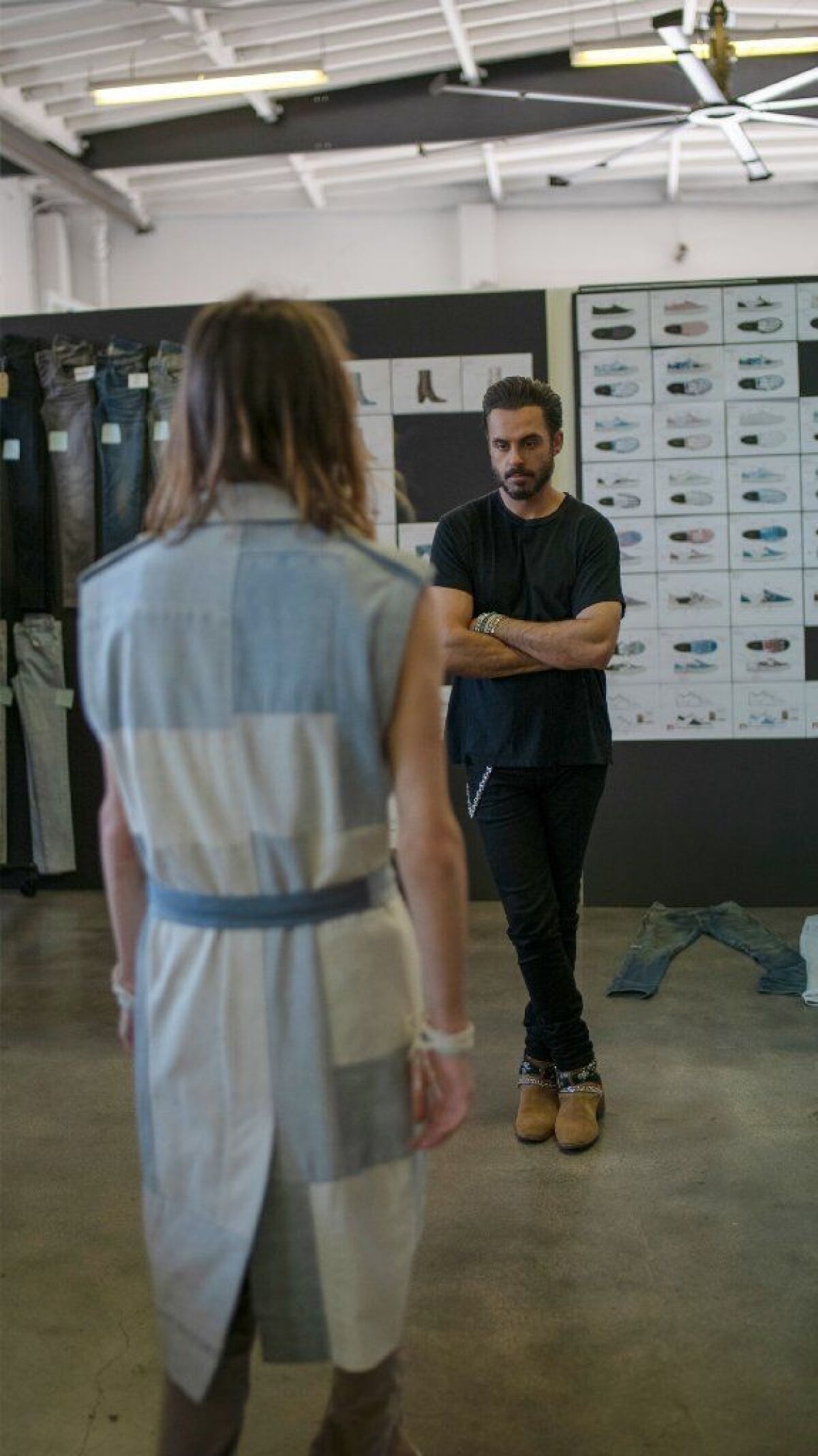 Mike Amiri surveys a recent design during a fitting session at his downtown L.A. studio. Among the celebrities wearing his clothes are Jay-Z, Kendrick Lamar and Gigi Hadid.