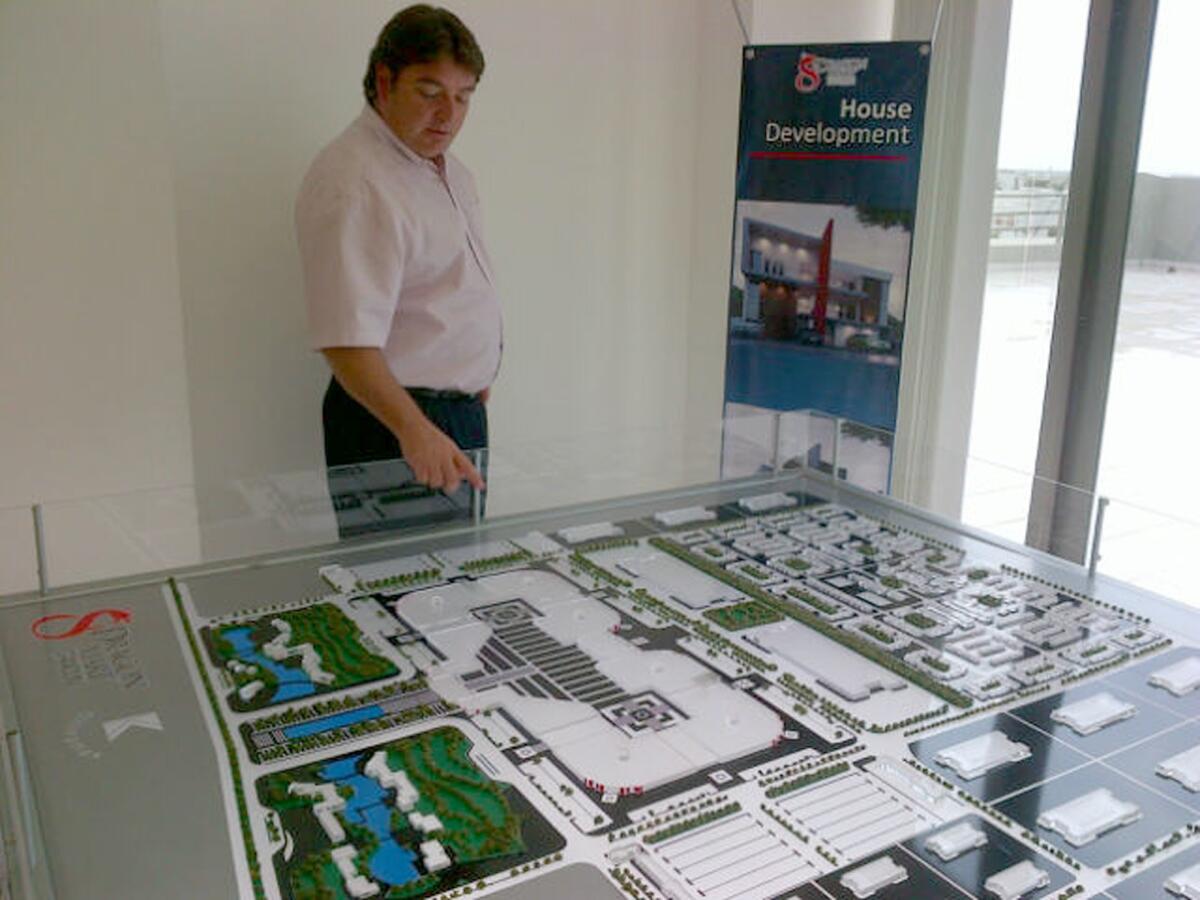 Juan Carlos Lopez, executive director of the Dragon Mart project, looks at a model of the proposed retail center in May 2013.