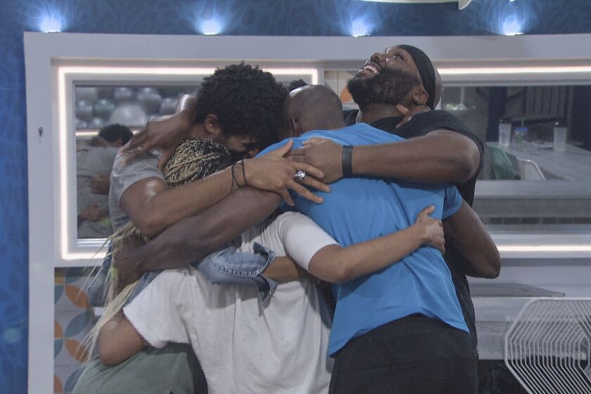Reality show contestants in a group hug