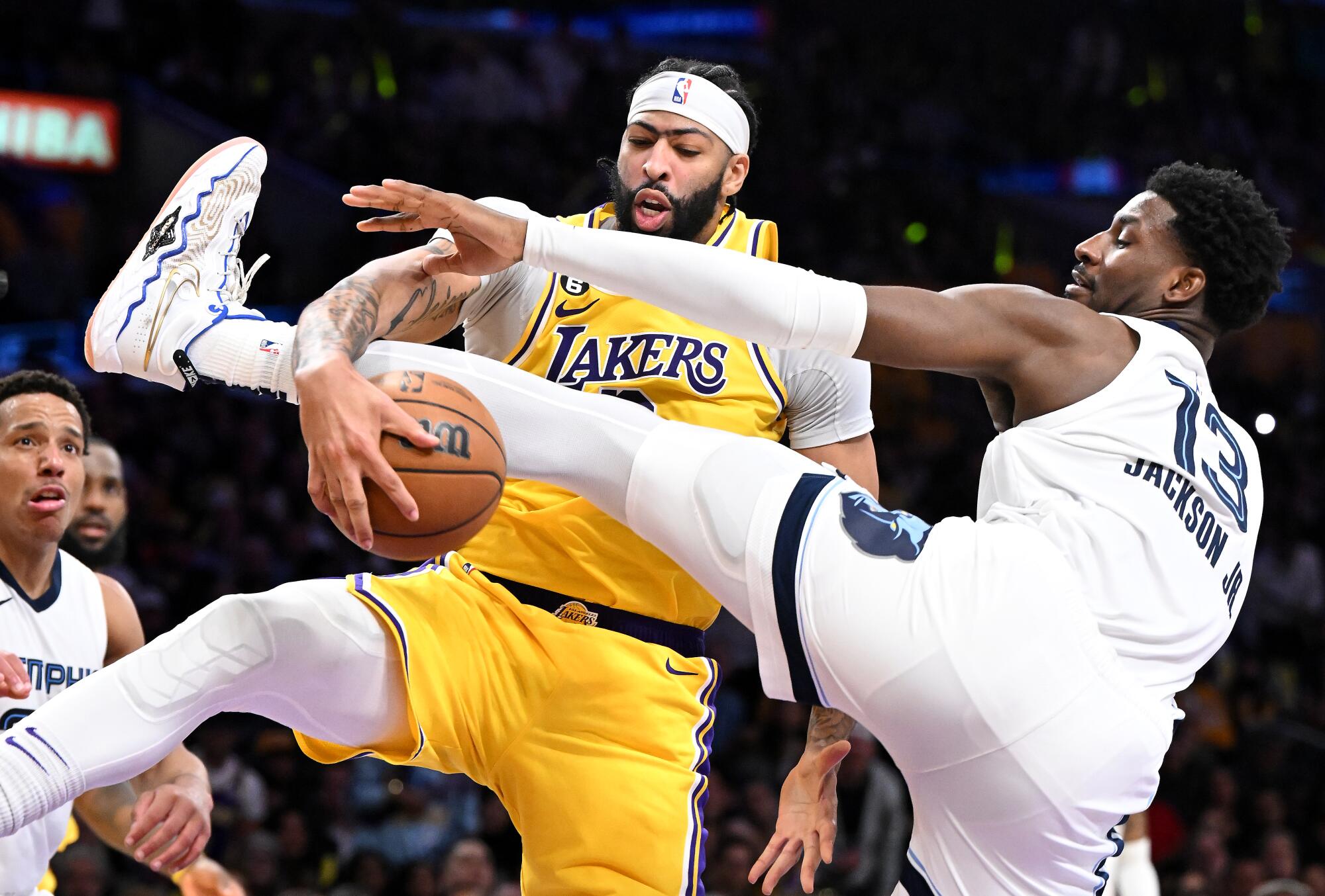 Lakers forward Anthony Davis, left, grabs a rebound away from Memphis Grizzlies forward Jaren Jackson Jr.